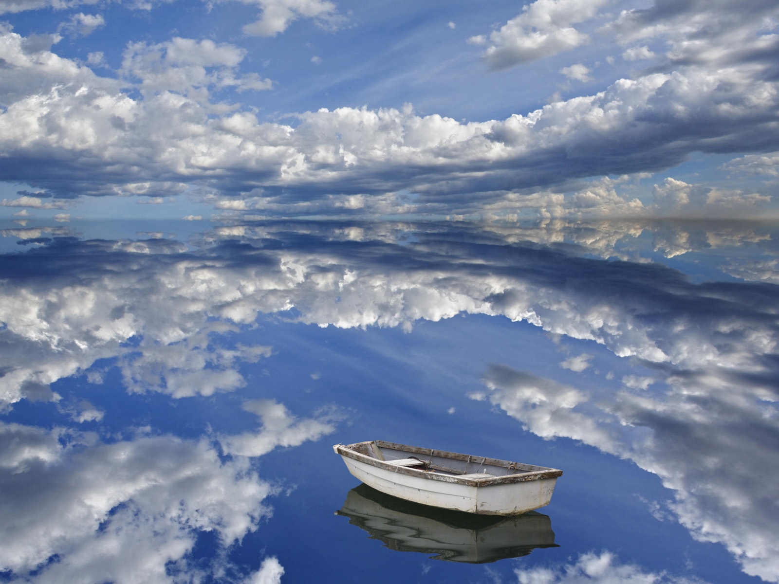Boat and clouds reflecting on ocean, Bar Harbor, Maine